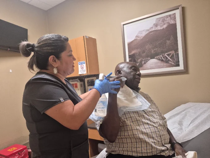 nurse checking a senior client's blood pressure at home