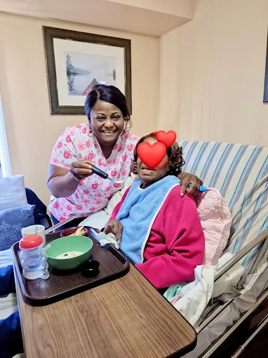 Beteli caregiver helping a client with a bedside meal